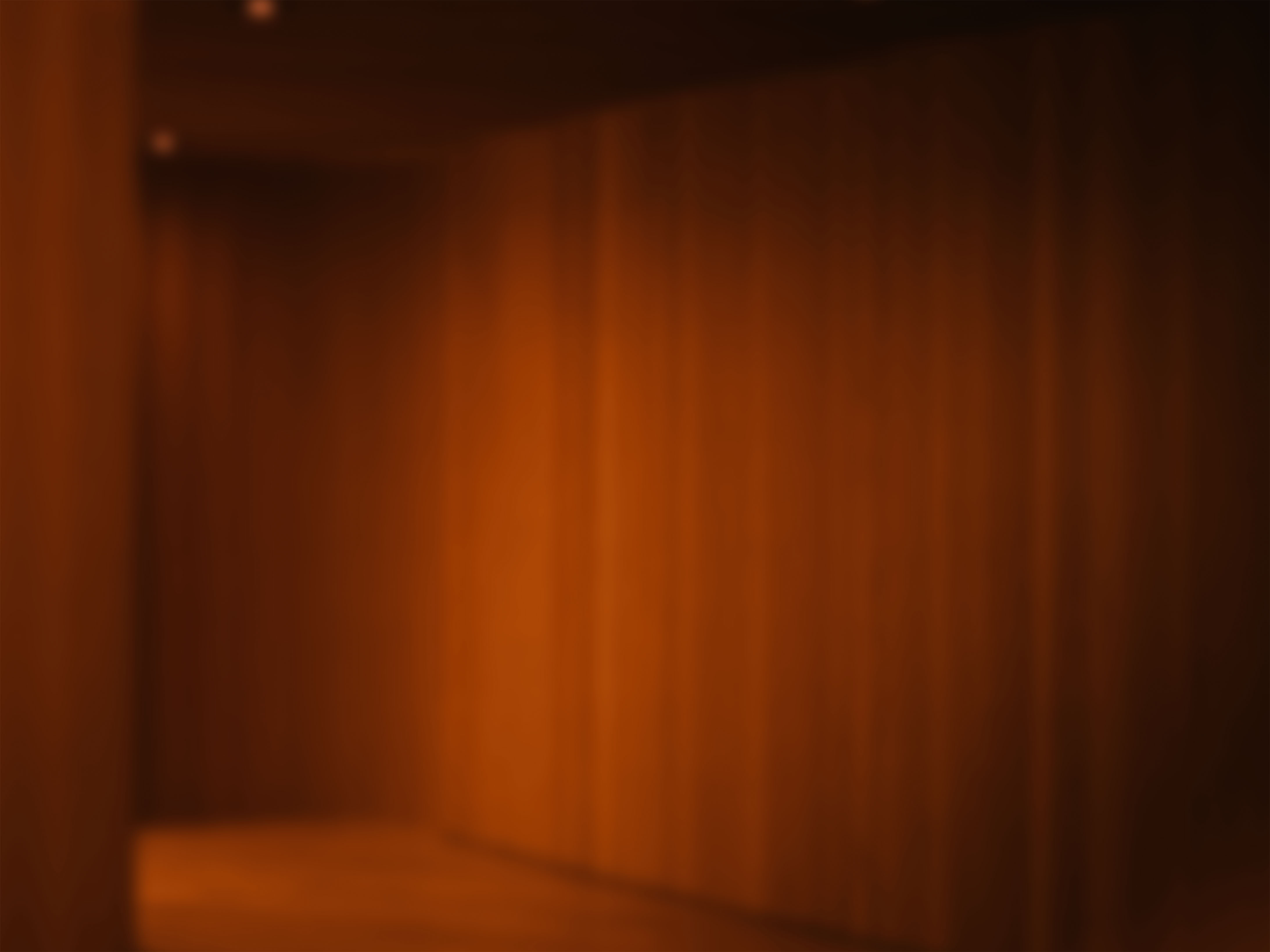 Warm-lit interior corner glowing in deep amber, abstracted to soft vertical bands